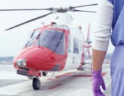A stock image of a doctor waiting on tarmac for a aeromed helicopter.