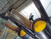 A photograph of a scientist assessing an F-111 airframe.