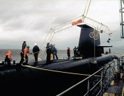 A photograph of HMAS Farncomb being fitted with the pickups for accoustic imaging trials.