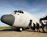 Soldiers board a C-130J aircraft in Timor Leste.