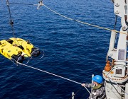 Image of HMAS Huon recovering its Double Eagle Unmanned Underwater Vehicle following a successful mine shape identification during a Mine Counter Measures and Hydrography exercise.