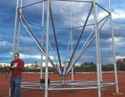 An image of a man in front of a radar array.