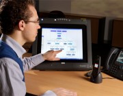 A young man pointing at a computer screen