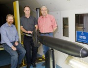 Three scientists with a submarine model in DST's Low Speed Wind Tunnel. Three scientists with a submarine model in DST's Low Speed Wind Tunnel.