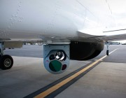 An aircraft with surveillance cameras mounted below it.