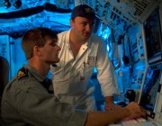 Pic of an Australian Navy Submarine's officers reviewing an undersea computer system.