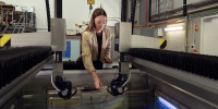 Defence scientist Hannah Spratling adjusts a probe on DSTG’s immersion scanner, prior to conducting non-destructive testing of material samples. 