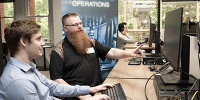 Mr Tim Pitts (DSTG) chats to IW Scholarship student Ethan Selway (University of Adelaide). 