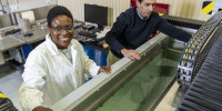 Dr Chirima (left) and fellow researcher Dr Matthew Ibrahim with DSTG’s ultrasonic immersion system which is able to measure the speed of sound, transmission loss and reflection coefficients of Dr Chirima’s material samples which are immersed in the water.