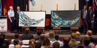 Chief of the Defence Force Air Chief Marshal Mark Binskin, AC, Warrant Officer Class One (Rtd) Roy Mundine, OAM, Chief Defence Scientist Dr Alex Zelinski and Mr Harry Allie unveil the female version of "The Song Cycle of the Seven Sisters" by Artist Anthony Walker during the 'Education as a Life Long Journey' event.