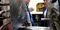 Jim Grose (left), Managing Director of Axiom, and Ben Barona, from DST, examining the injection moulding die being used to produce face shield headbands.