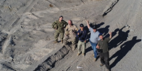 Bin Lee (centre) with four DRDC colleagues testing the new CADPAT (MT) uniform and other developmental materials at 29 Palms, California in November 2022.The Marine Corps Air Ground Combat Center (MCAGCC), also known as 29 Palms, is the largest United States Marine Corps base.