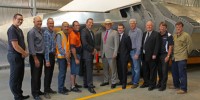 A photograph of the Minister for Defence Science and Personnel standing with DSTO personnel in front of the model of the Joint Strike Fighter.