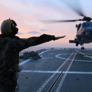 Image of a soldier signalling to a helicopter.